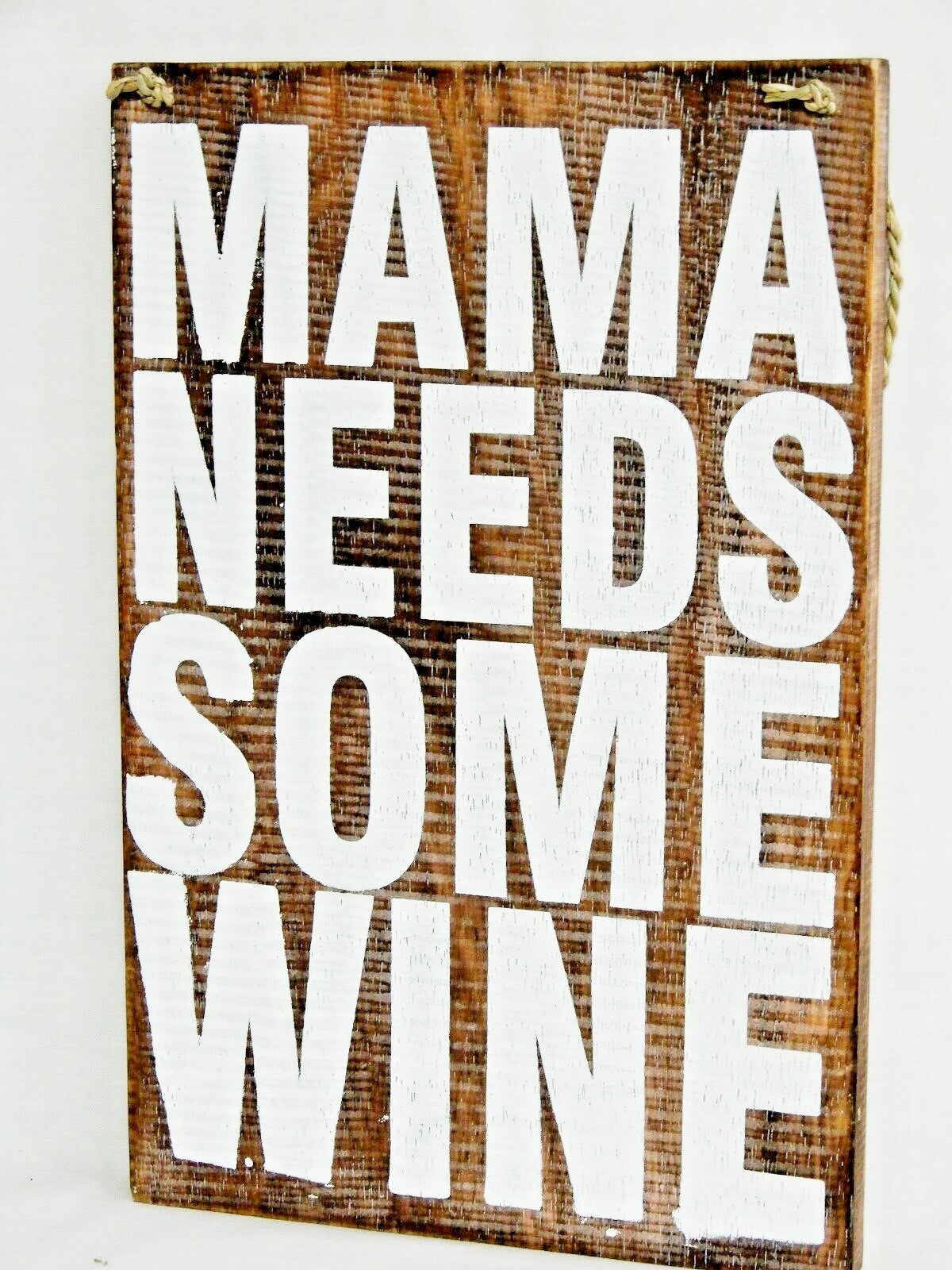 A wooden sign that says - 'Mama needs some wine"