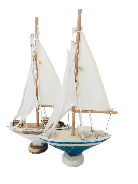 A wooden sailing yacht style boat. With a mast made out of white material material. Available in white or blue. 