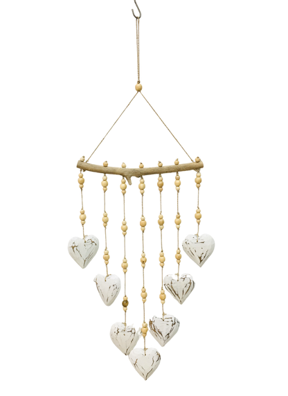A hanging mobile with seven white love hearts and brown patterned carving on each heart. 