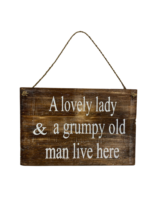 A Lovely Lady & A Grumpy Old Man Live Here sign