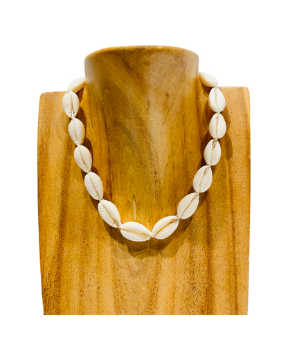 Adjustable cowrie necklace with white shells and white string.